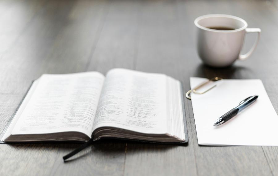 Image of a Bible on a table with a mug