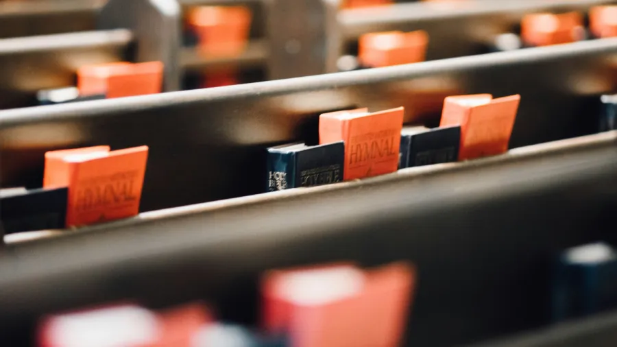 Photo of hymnals in church pews