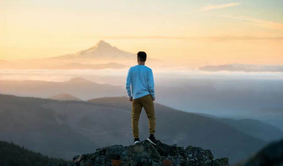 Image of individual standing on a mountain top