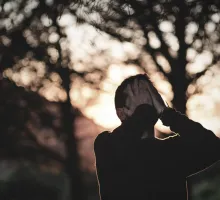 Photo of a man in sorrowful prayer