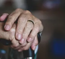 Image of elderly woman's hands on a cane