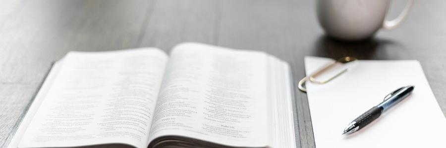 Image of a Bible on a table with a mug