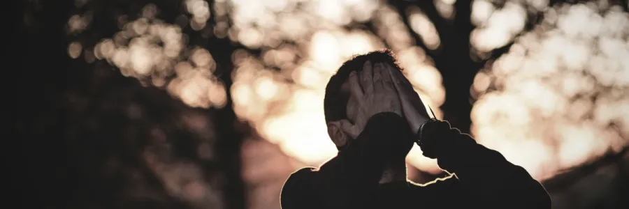 Photo of a man in sorrowful prayer