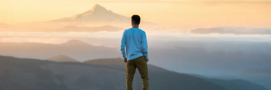 Image of individual standing on a mountain top