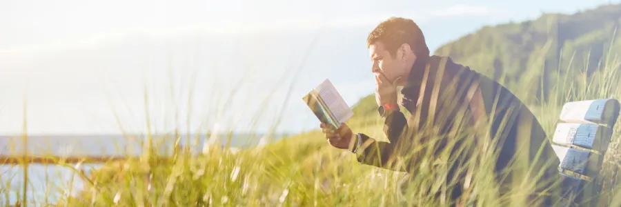 Image of a man reading thoughtfully