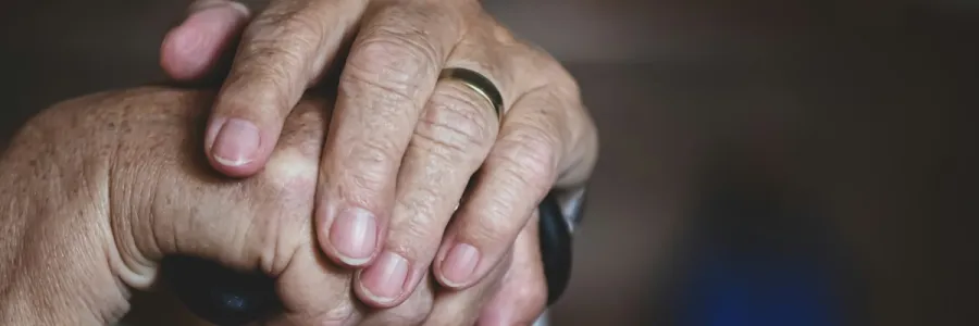 Image of elderly woman's hands on a cane